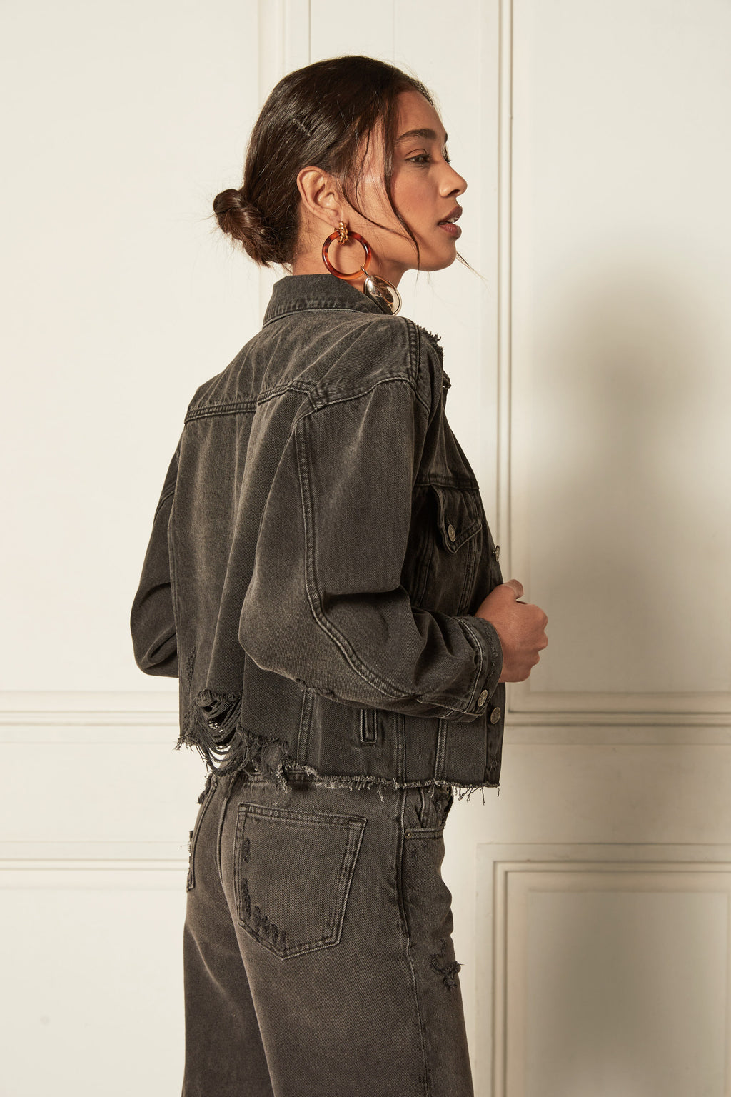 Video - The Harvey - Fatal Attraction is a cropped denim jacket in a vintage black wash with destruction. Made with GRS-certified recycled cotton.